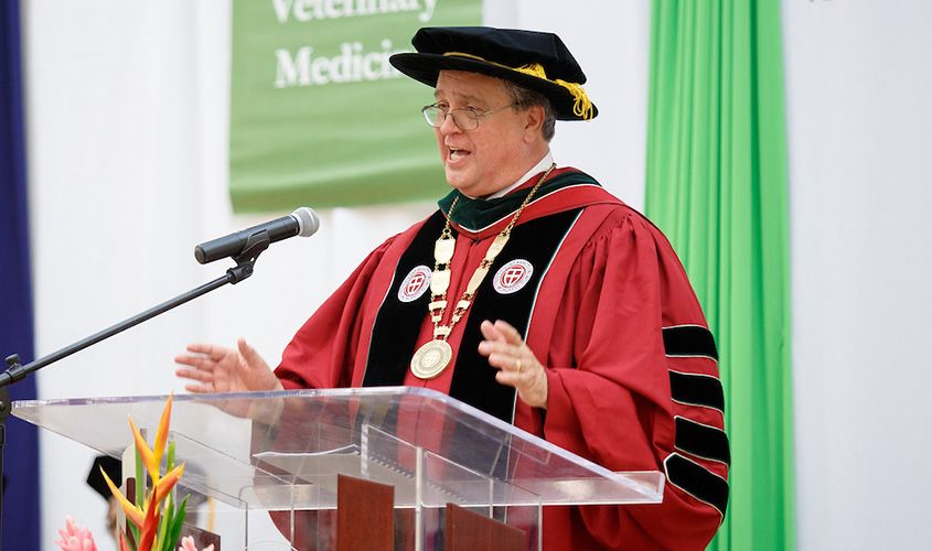 University President Dr. G. Richard Olds delivers a commencement address in academic regalia.