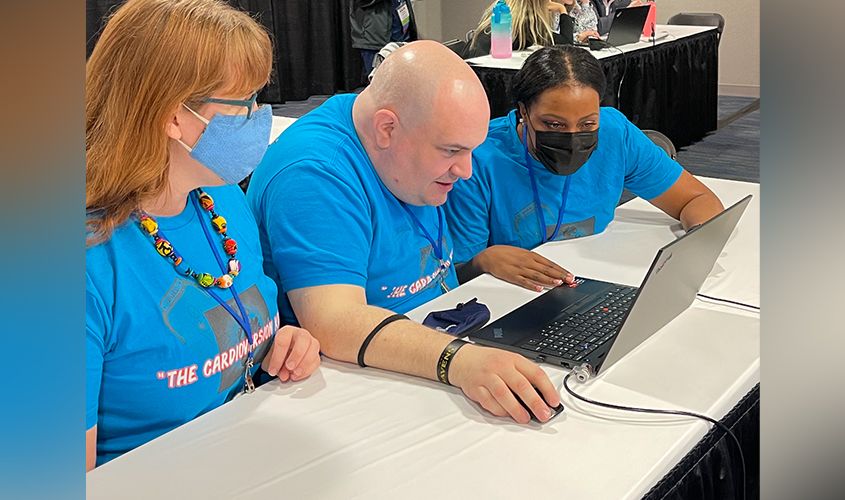 Three medical students, "The CardioversionKids," collaborating on a laptop during the AMSACon simulation challenge. News