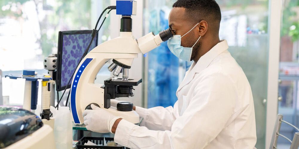 Cytopathologist examining samples under microscope