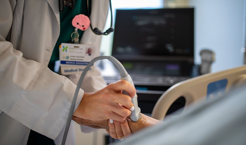 Medical student on clinical rotation discussing a case with a physician in a hospital News
