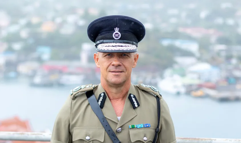 Edvin Martin, St. George's University alumnus and Commissioner of the Royal Grenada Police Force smiles wearing his uniform.