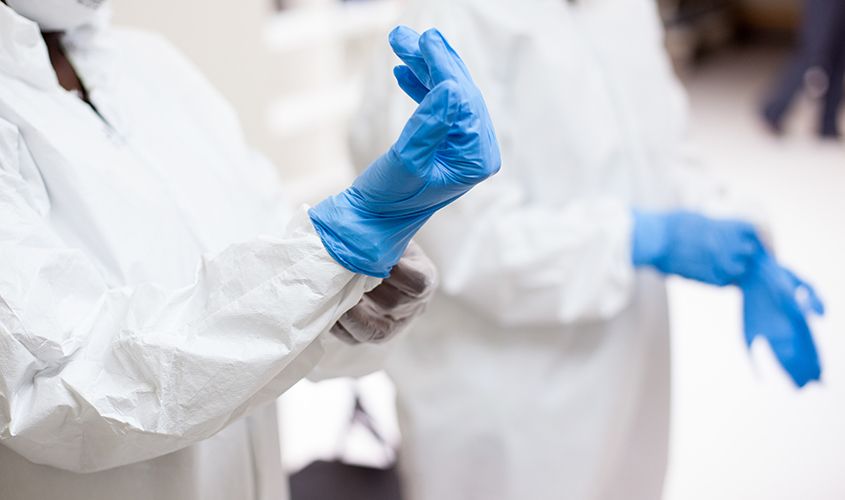 Surgeon or medical professional carefully donning sterile surgical gloves