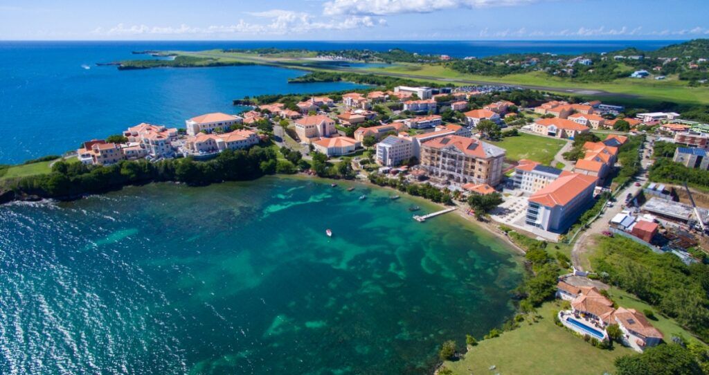 Panoramic view of the lush, mountainous island landscape and turquoise Caribbean Sea surrounding Grenada