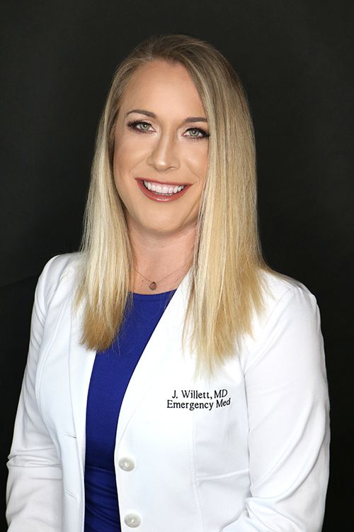 Dr. J. Willett, an emergency medicine physician, smiling in a white lab coat News