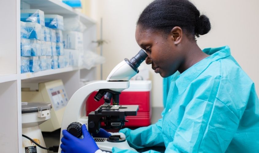 A student conducting research in a lab, illustrating the academic focus of SGU's Research Day event in October. News
