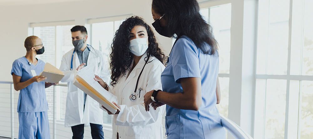 A medical student discusses charts with a doctor