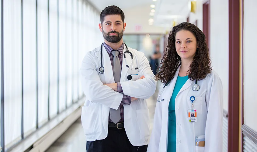 St. George’s University-trained doctors in hospital scrubs collaborating on patient care. News