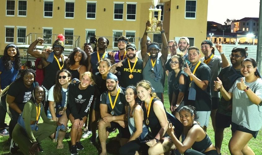 SGU medical students celebrating with a trophy and medals after winning the SOM Olympics event News