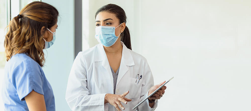 Pre-med student gaining clinical experience by shadowing a physician