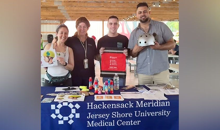 SGU medical students smile at their community service booth during a Jersey Shore outreach event.