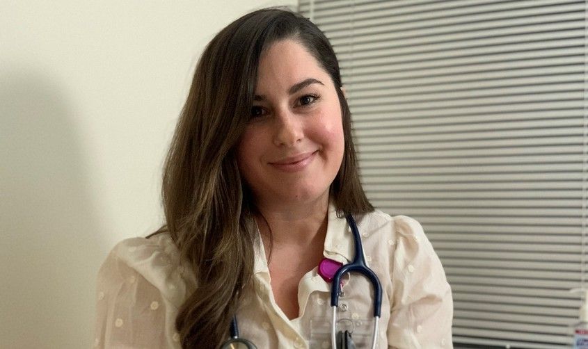 Smiling female medical professional with a stethoscope around her neck