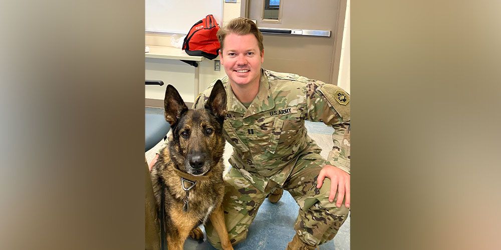 Matt Morgan, DVM '11, with dog in US Army Veterinary Corps