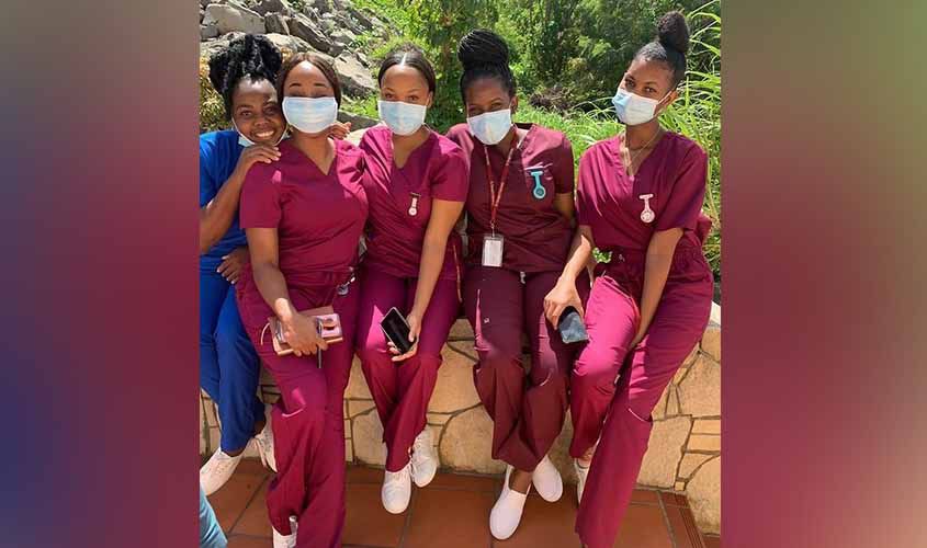 SGU medical students volunteering in a community health event, providing care and support to local residents.