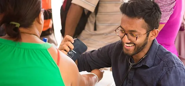 St. George’s University student taking blood pressure measurement.