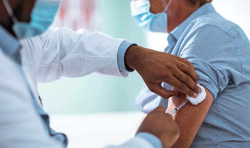 Close-up shot of a doctor giving a vaccine shot for immunization